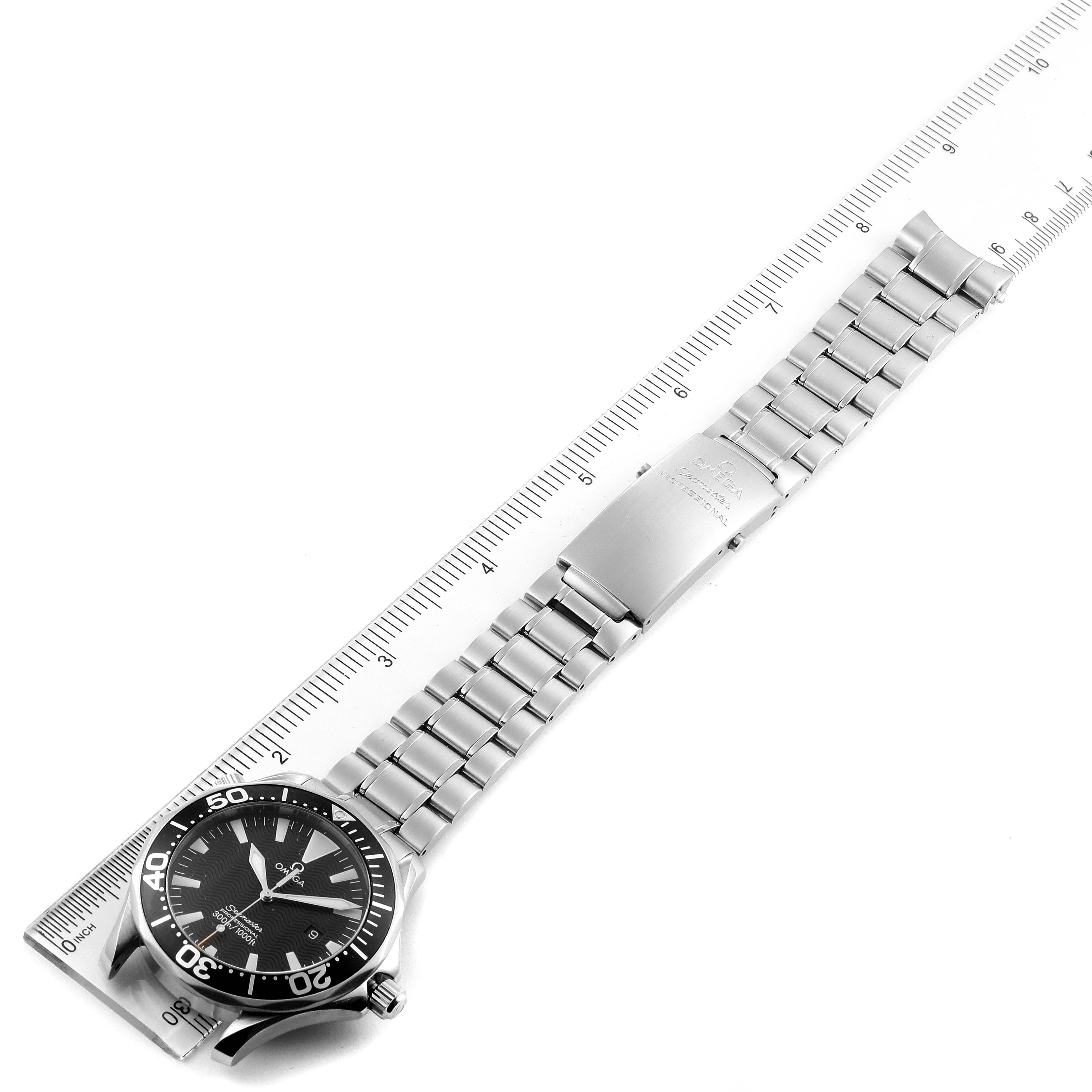 This image shows a side view of an Omega Seamaster 2264.50.00 Men
s Stainless Steel Black Dial 2264.50.00 Men
s Stainless Steel Black Dial watch laid flat next to a ruler, showcasing the face and entire bracelet.