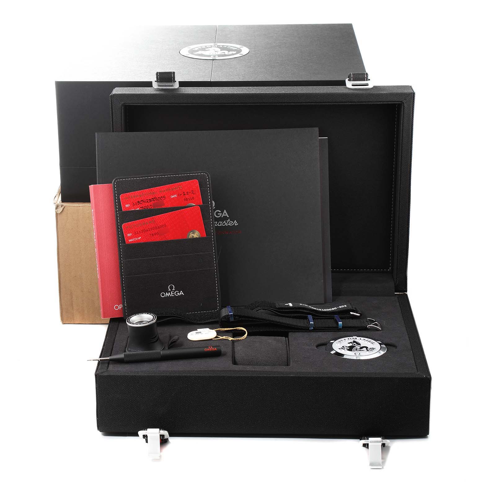 The image shows the Omega Speedmaster 311.30.42.30.01.005 Men's Stainless Steel Black Dial 311.30.42.30.01.005 Men's Stainless Steel Black Dial watch accessories, including a strap, tools, warranty cards, and packaging box.