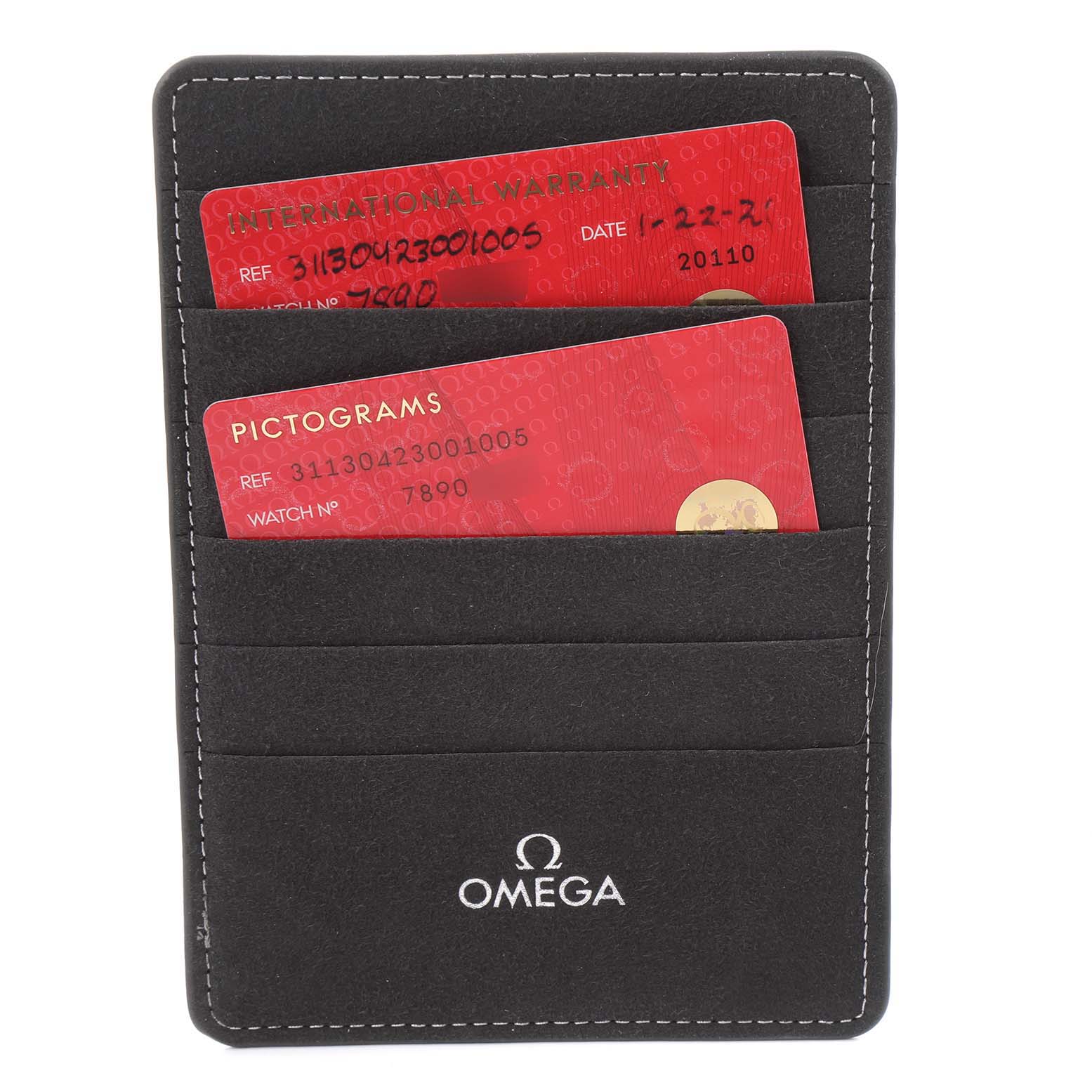 The image shows warranty and pictogram cards for an Omega Speedmaster 311.30.42.30.01.005 Men's Stainless Steel Black Dial 311.30.42.30.01.005 Men's Stainless Steel Black Dial, placed in a black cardholder with the Omega logo.