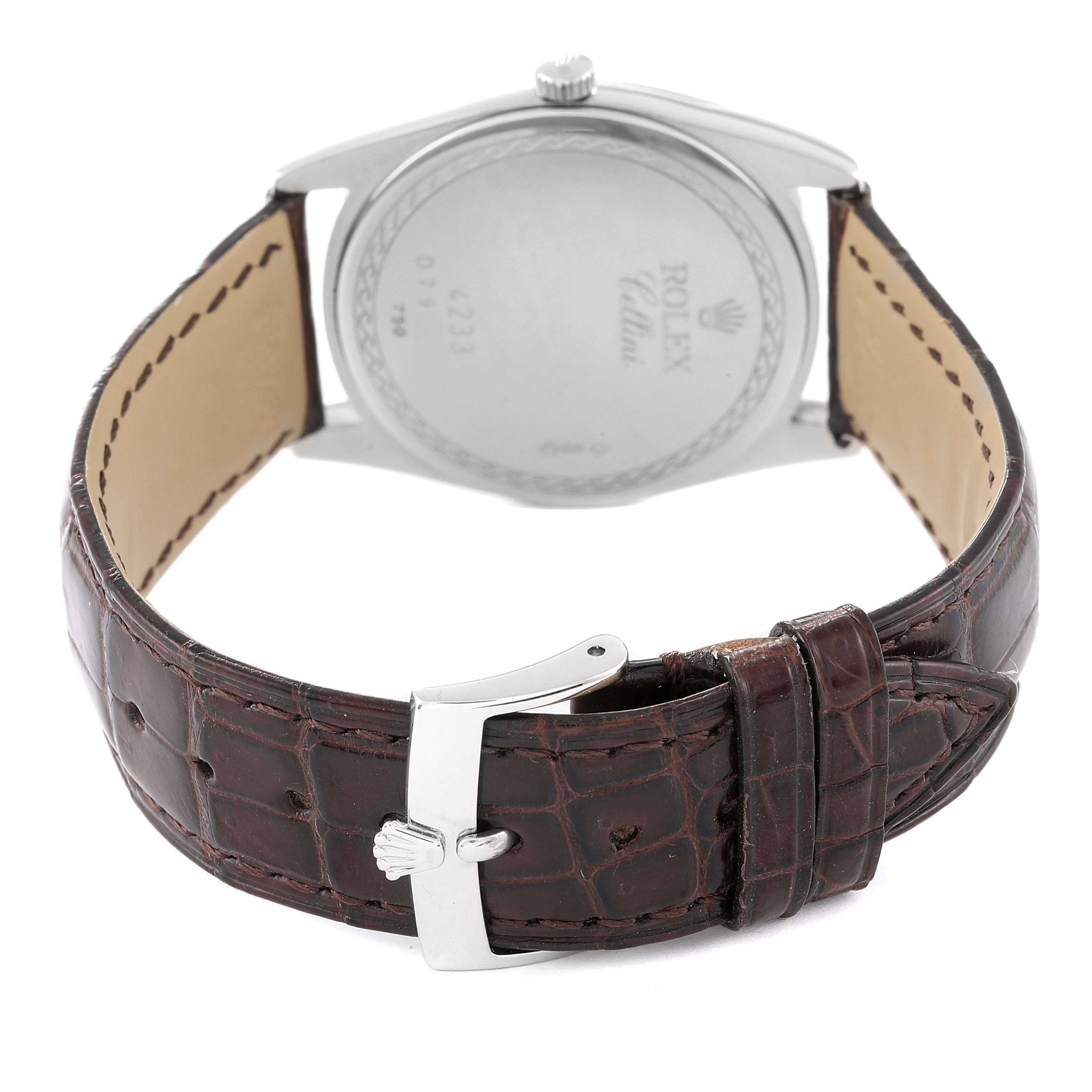 The image shows the back of a Rolex Cellini 4233 Men
s Rose Gold White Dial 4233 Men
s Rose Gold White Dial watch and its brown leather strap with the buckle visible.