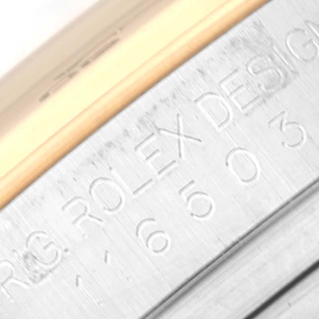 This close-up image shows the engraved side of the casing for a Rolex Daytona 116503 Men
s Steel and Gold (two tone) Black Dial 116503 Men
s Steel and Gold (two tone) Black Dial watch.