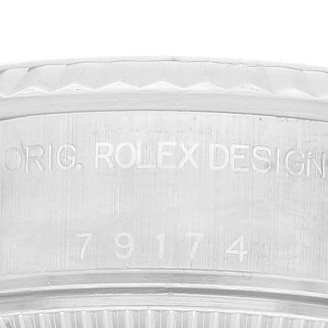 The image shows an engraved section from the side of the bezel of a Rolex Datejust 79174 Women's Stainless Steel Silver Dial 79174 Women's Stainless Steel Silver Dial watch.