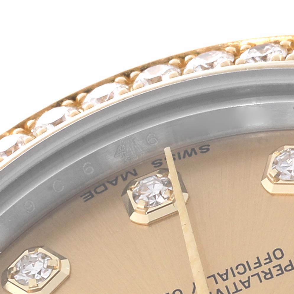 Close-up of a Rolex Mid-Size 178383 Women
s Steel and Gold (two tone) Champagne Dial 178383 Women
s Steel and Gold (two tone) Champagne Dial model showing the diamond-set bezel, part of the dial, and the minute hand.