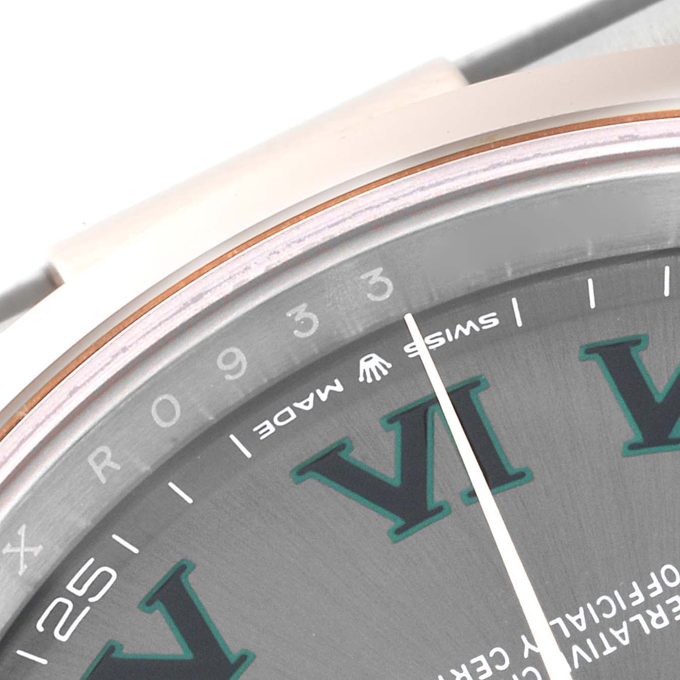 This close-up image of the Rolex Datejust 41 126301 Men's Steel and Gold (two tone) Grey Dial 126301 Men's Steel and Gold (two tone) Grey Dial watch shows part of the dial, bezel, and the "Swiss Made" text.