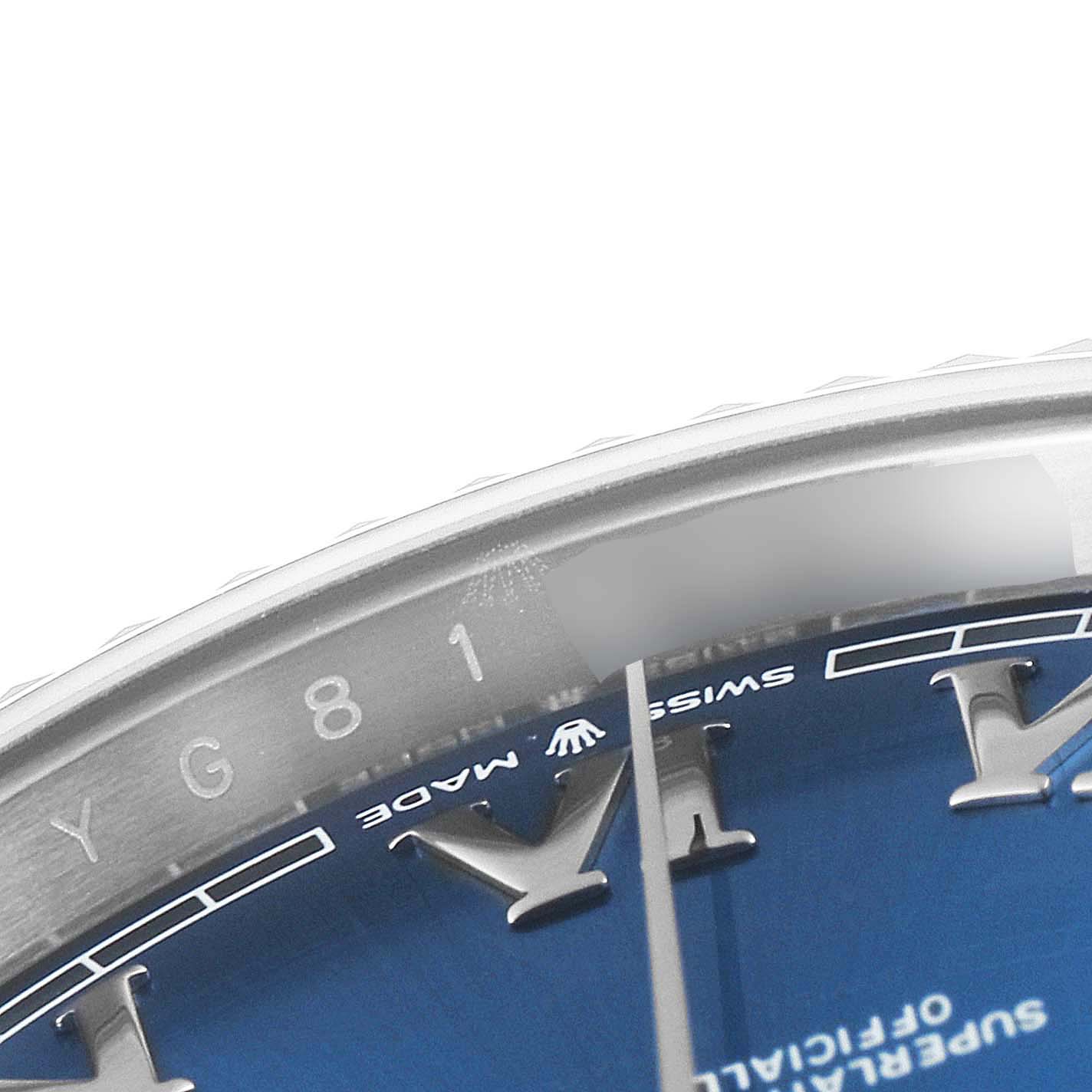 This close-up of the Rolex Datejust 41 126334 Men
s Stainless Steel Blue Dial 126334 Men
s Stainless Steel Blue Dial watch shows a portion of its blue dial, part of the bezel, and numerals.