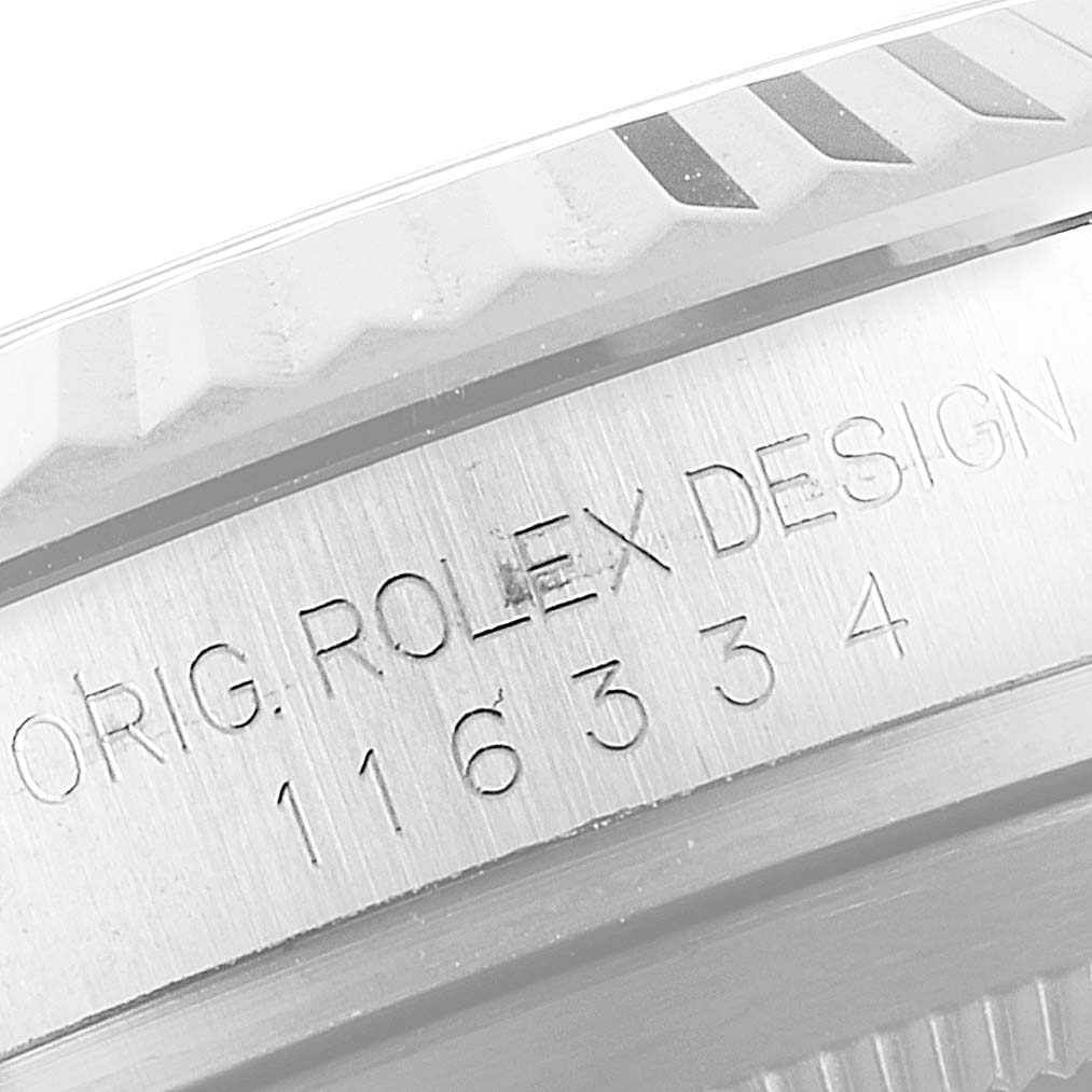 This close-up image of a Rolex Datejust 41 116334 Men
s Stainless Steel Black Dial 116334 Men
s Stainless Steel Black Dial model shows the engraved writing and fluted bezel.