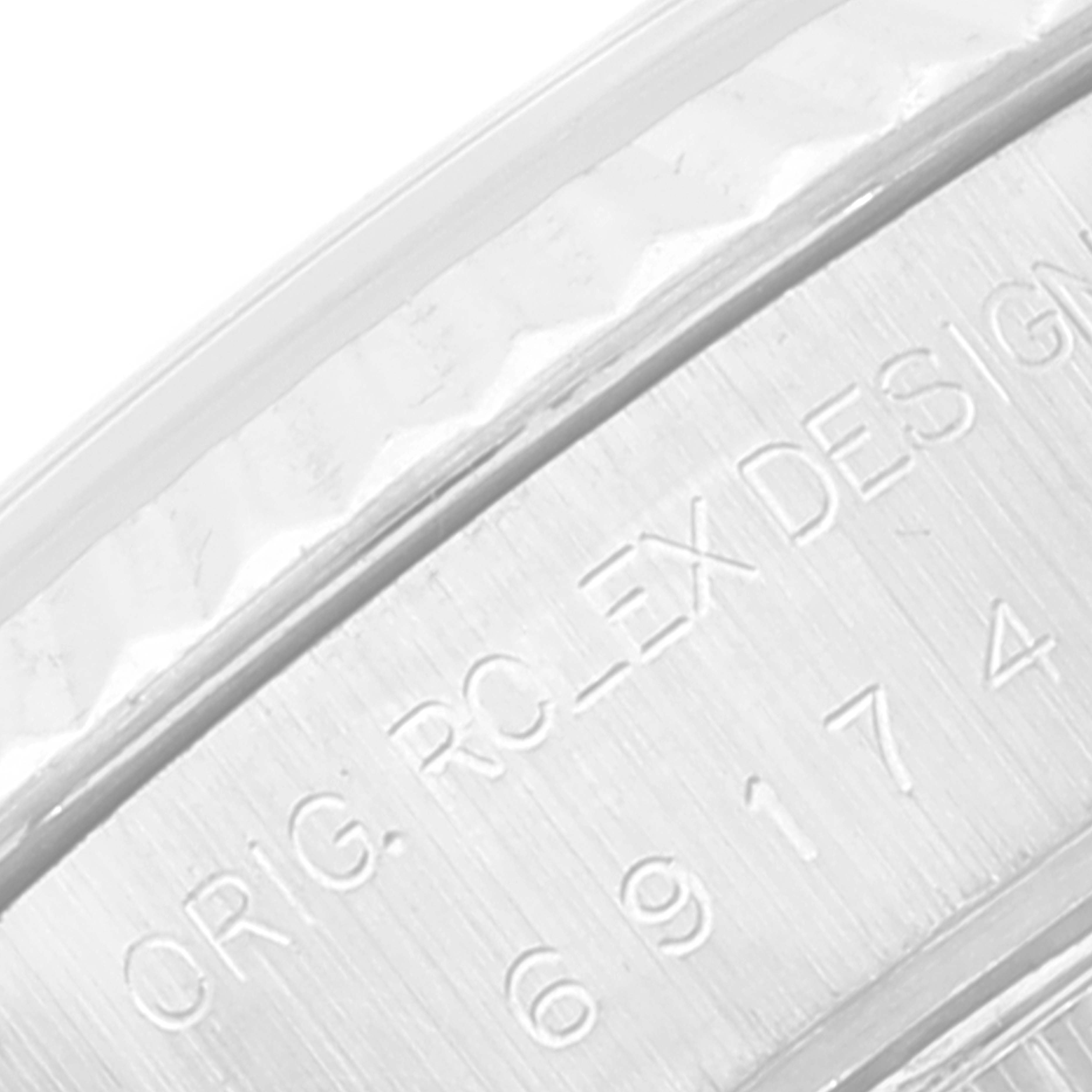 The image shows a close-up view of the Rolex Datejust 69174 Women's Stainless Steel Pink Dial 69174 Women's Stainless Steel Pink Dial model's rehaut with engraved serial numbers.