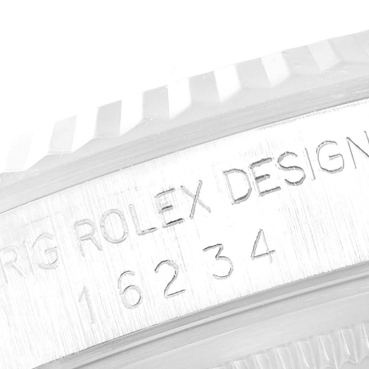 The image shows a close-up of the engraved model number and part of the bezel of a Rolex Datejust 16234 Men's Stainless Steel Silver Dial 16234 Men's Stainless Steel Silver Dial watch.