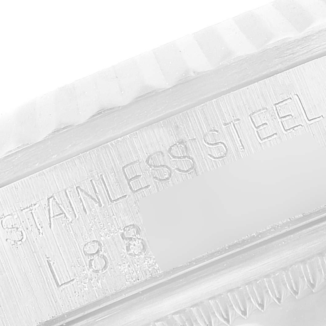 This image shows a close-up of the stainless steel bezel and part of the engraved text on a Rolex Datejust 16234 Men's Stainless Steel Silver Dial 16234 Men's Stainless Steel Silver Dial.