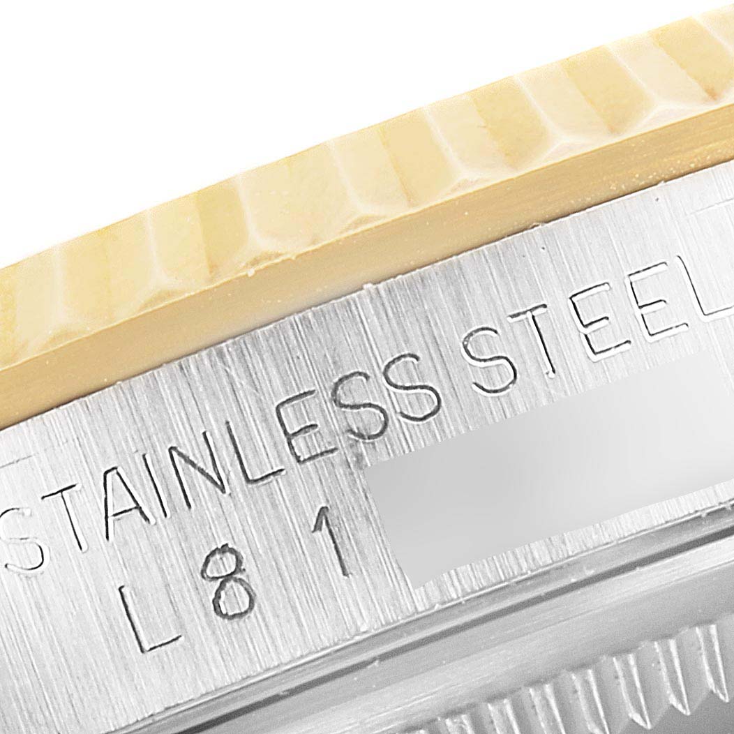 The image shows a close-up of the stainless steel casing with text "STAINLESS STEEL" and part of the bezel of a Rolex Datejust 16233 Men's Steel and Gold (two tone) Champagne Dial 16233 Men's Steel and Gold (two tone) Champagne Dial watch.