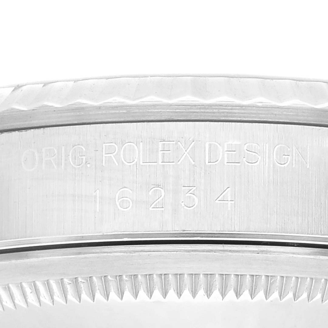 The image shows a close-up of the side and bezel of a Rolex Datejust 16234 Men's Stainless Steel Blue Dial 16234 Men's Stainless Steel Blue Dial watch, displaying its engraved design and model number.