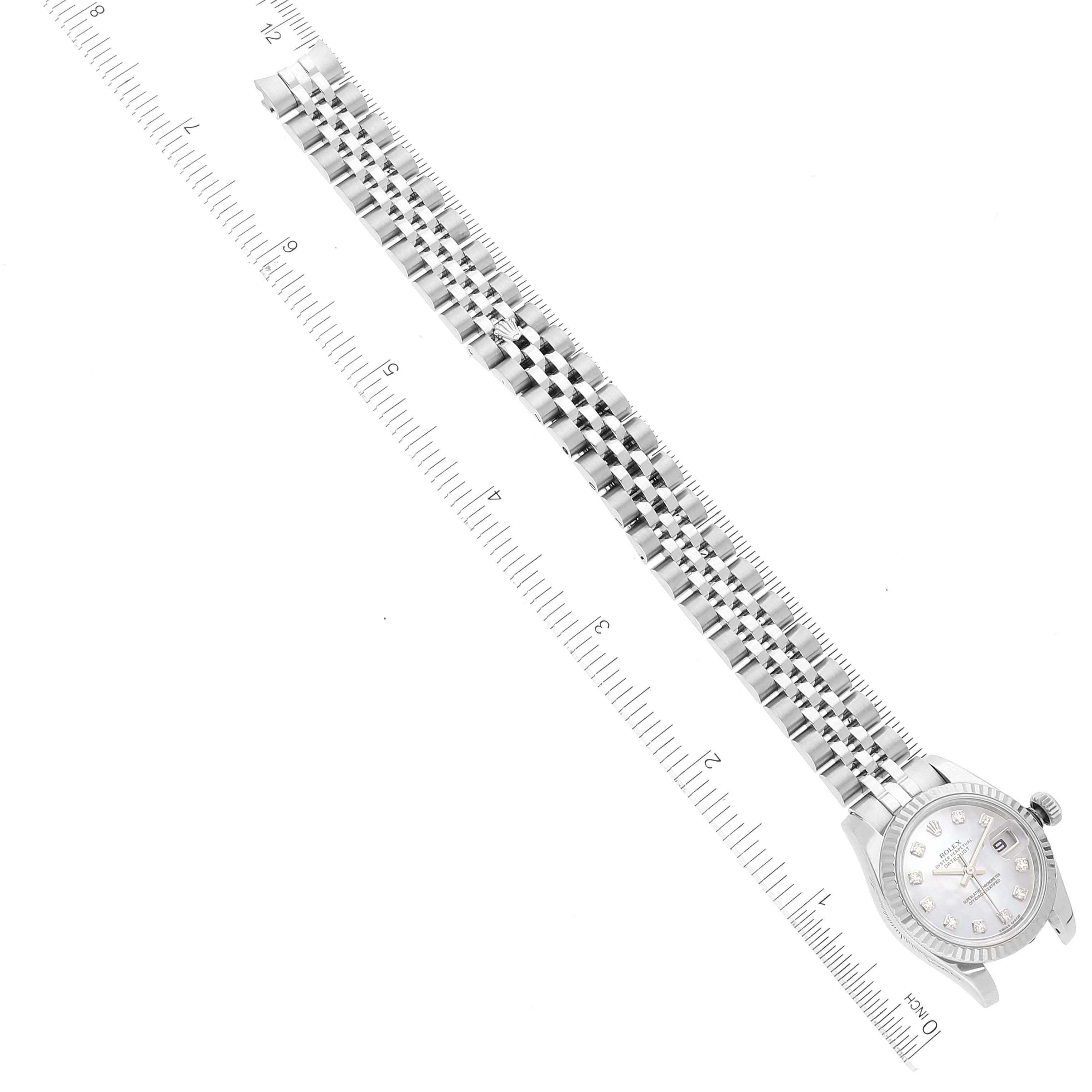 The image shows a Rolex Datejust 179174 Women's Stainless Steel Mother of Pearl Dial 179174 Women's Stainless Steel Mother of Pearl Dial watch laid horizontally with a ruler measuring the length of its metal bracelet.