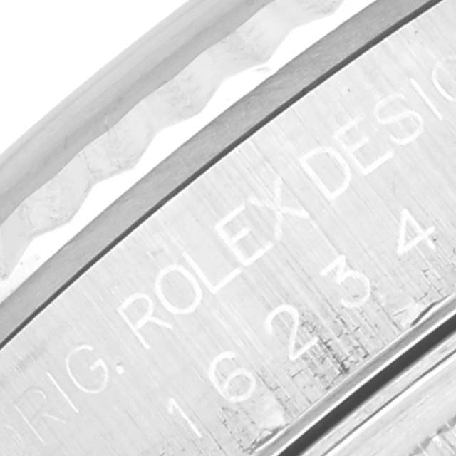 The image shows a close-up side view of the engraved bezel and case of a Rolex Datejust 16234 Men's Stainless Steel White Dial 16234 Men's Stainless Steel White Dial watch.