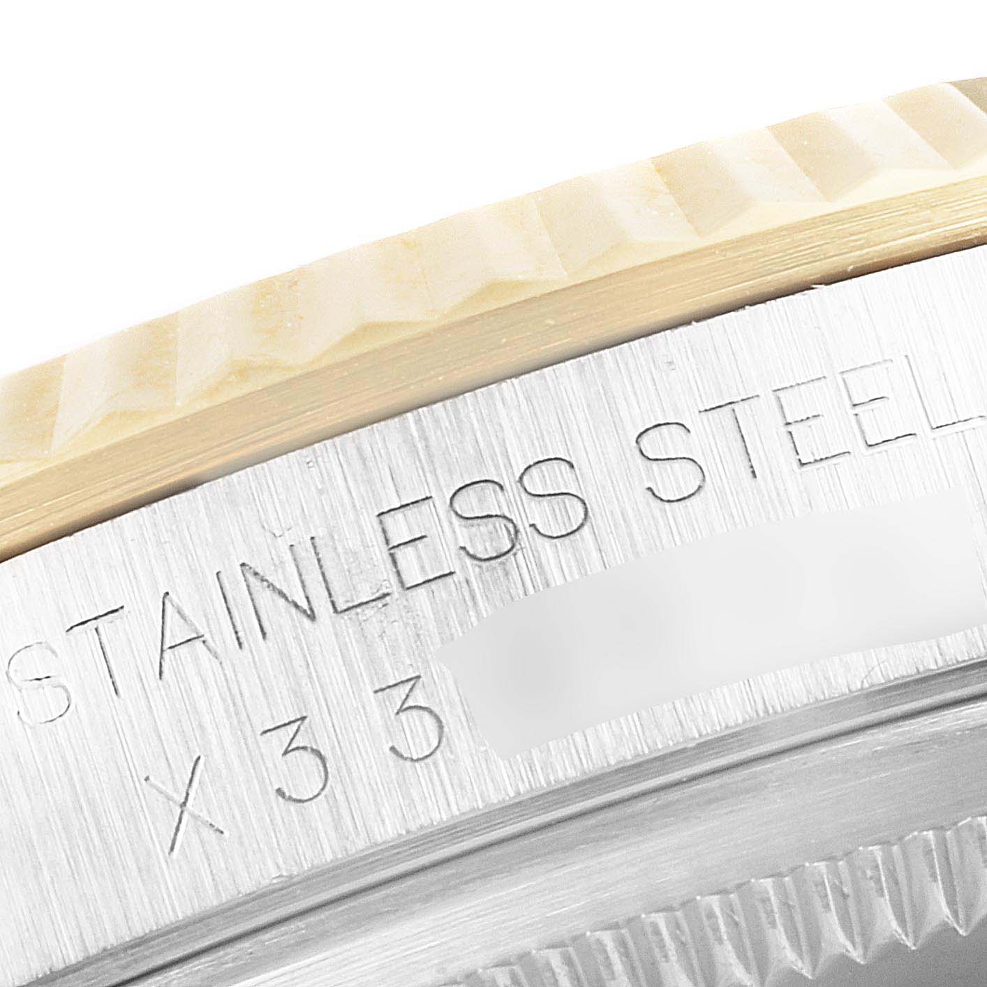The image shows a close-up of the bezel and part of the case back of a Rolex Datejust 16233 Men's Steel and Gold (two tone) Black Dial 16233 Men's Steel and Gold (two tone) Black Dial watch, highlighting the stainless steel engraving.