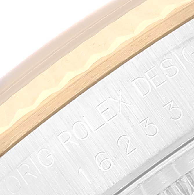 The image shows a close-up of the side casing with engravings of a Rolex Datejust 16233 Men's Steel and Gold (two tone) Black Dial 16233 Men's Steel and Gold (two tone) Black Dial watch.