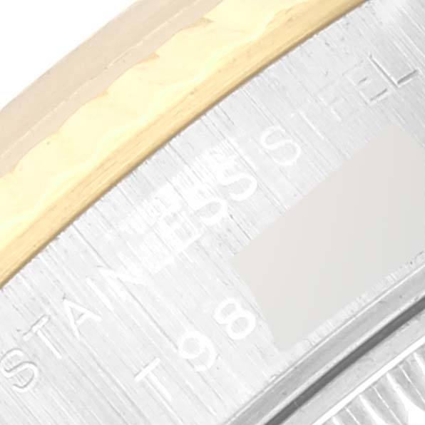 This image shows a close-up of the side of a Rolex Datejust 69173 Women's Steel and Gold (two tone) Champagne Dial 69173 Women's Steel and Gold (two tone) Champagne Dial watch, highlighting part of the bezel and case with engraved text.