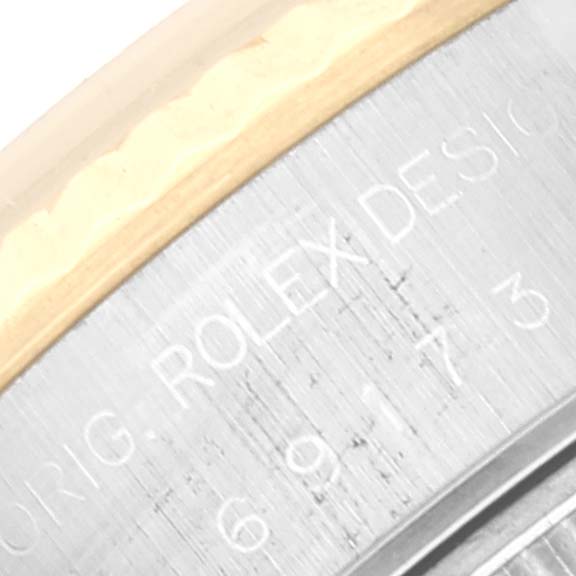 This is a close-up image of part of the watch case and bezel, showing engraving on the Rolex Datejust 69173 Women's Stainless Steel Champagne Dial 69173 Women's Stainless Steel Champagne Dial model.