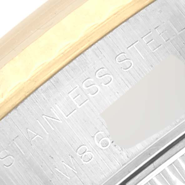 This image shows a close-up of the side of a Rolex Datejust 69173 Women's Stainless Steel Champagne Dial 69173 Women's Stainless Steel Champagne Dial watch, highlighting part of the case and bezel with "STAINLESS STEEL" engraved.