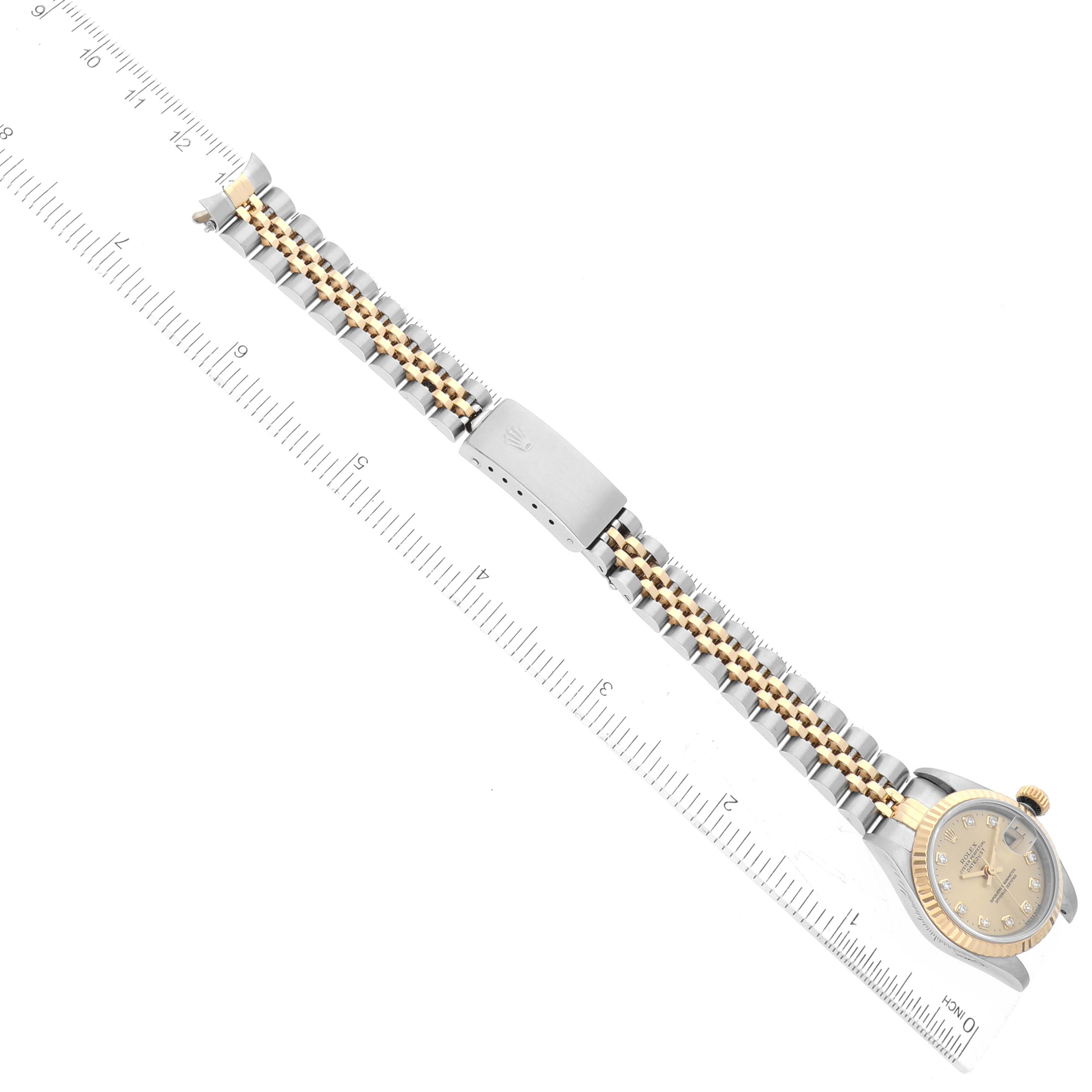 The image shows a Rolex Datejust 69173 Women's Stainless Steel Champagne Dial 69173 Women's Stainless Steel Champagne Dial watch laid flat, displaying both the face and the bracelet extended alongside a ruler.