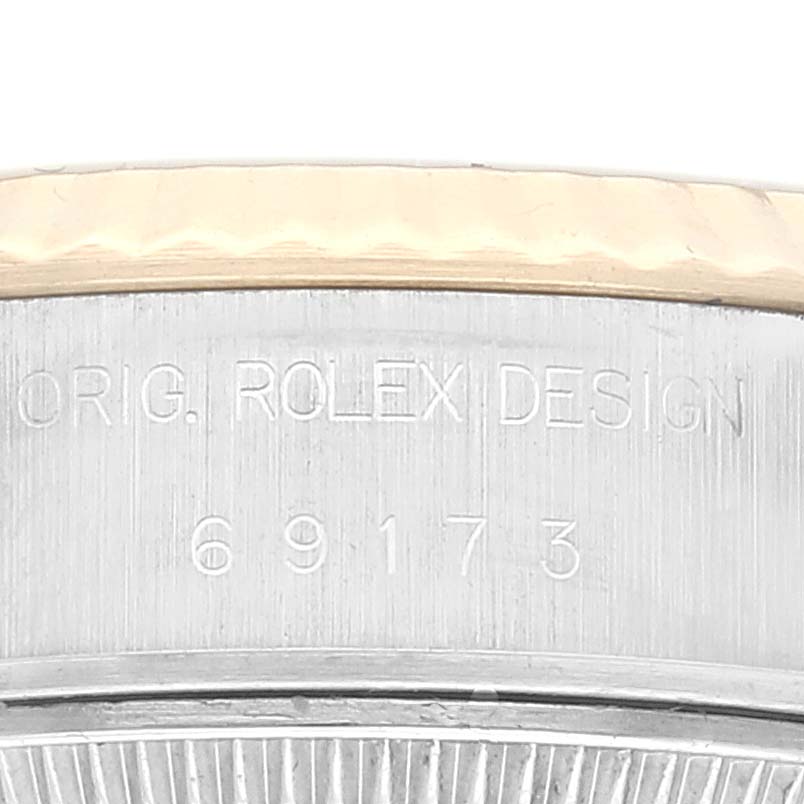This close-up image shows the engraved side of the case from a Rolex Datejust 69173 Women's Steel and Gold (two tone) Champagne Dial 69173 Women's Steel and Gold (two tone) Champagne Dial watch model.