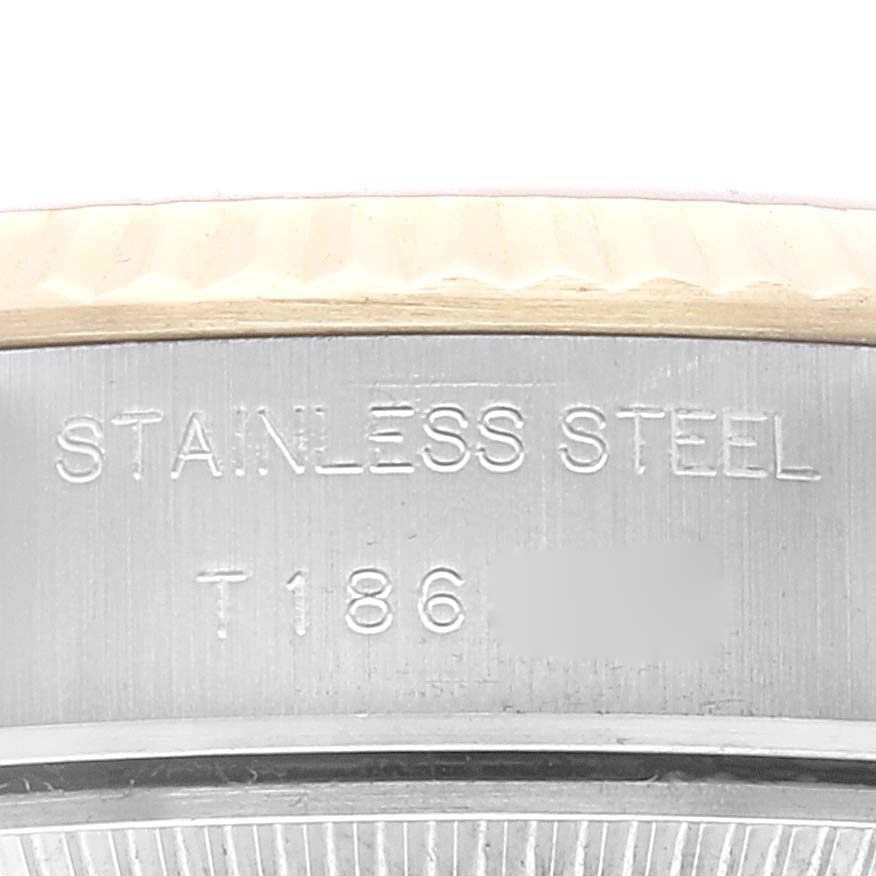 This close-up image shows the stainless steel engravings on the side of a Rolex Datejust 69173 Women's Steel and Gold (two tone) Champagne Dial 69173 Women's Steel and Gold (two tone) Champagne Dial watch case.