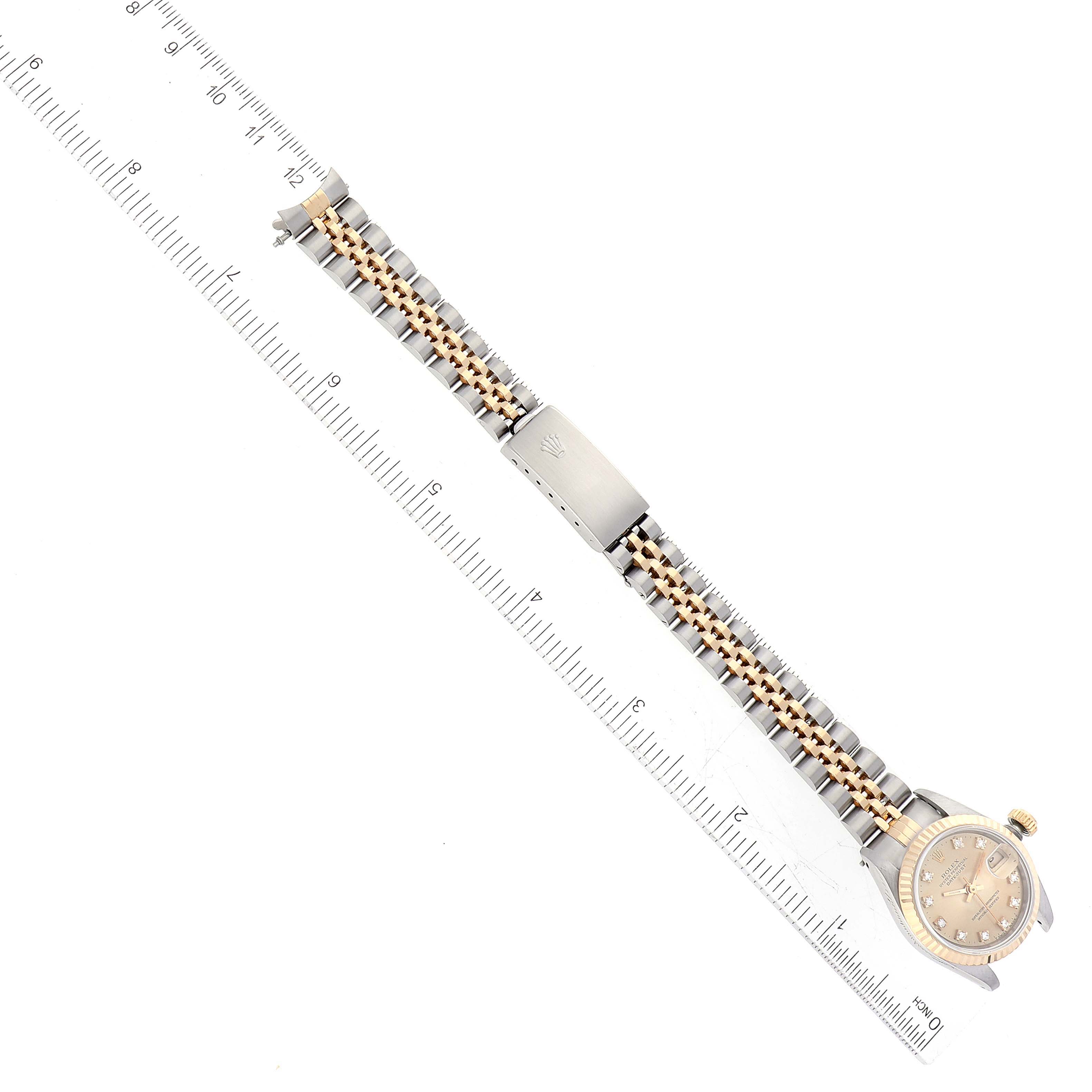 The image shows a top-down view of a Rolex Datejust 69173 Women's Steel and Gold (two tone) Champagne Dial 69173 Women's Steel and Gold (two tone) Champagne Dial watch, including its beaded bracelet with a clasp and the watch face.