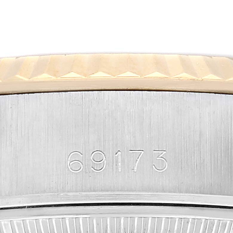 This image shows a close-up view of the case's side and visible serial number of a Rolex Datejust 69173 Women's Steel and Gold (two tone) Champagne Dial 69173 Women's Steel and Gold (two tone) Champagne Dial watch.