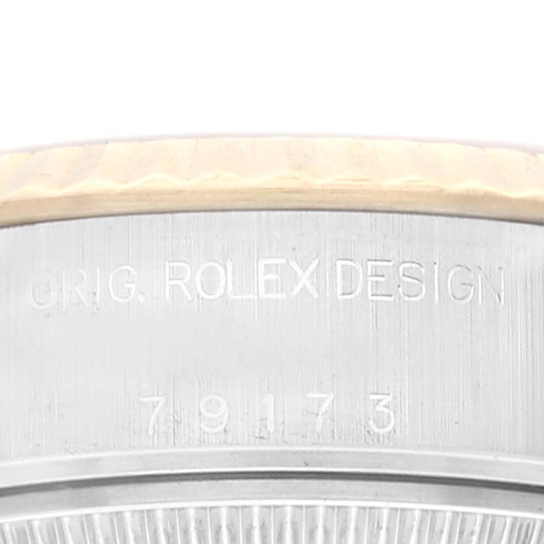 The image shows a close-up of the case side and serial number of a Rolex Datejust 79173 Women's Steel and Gold (two tone) Champagne Dial 79173 Women's Steel and Gold (two tone) Champagne Dial watch.