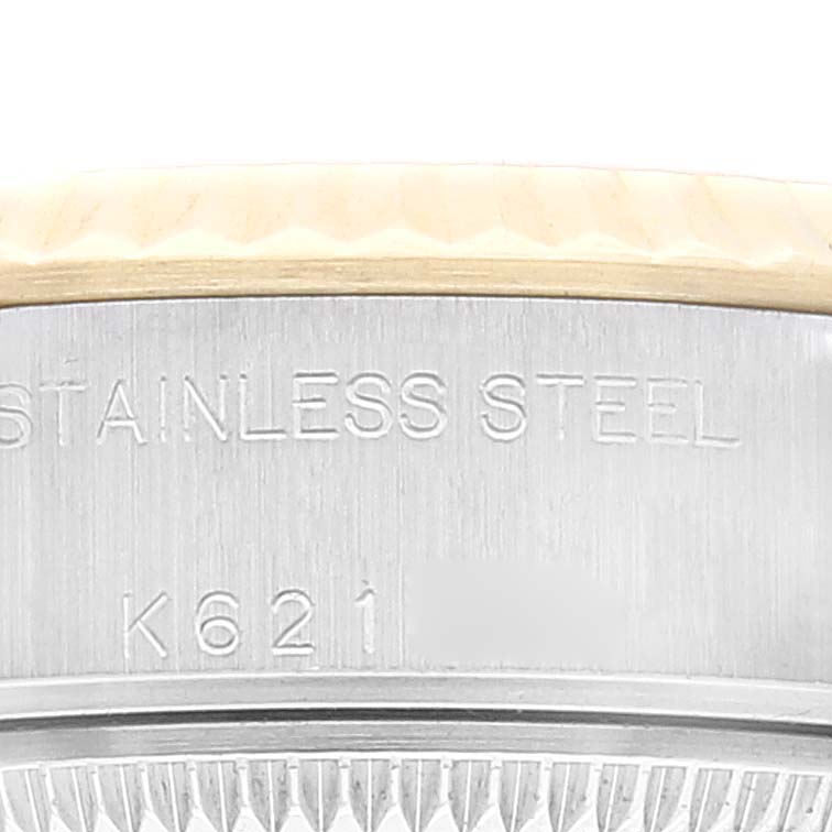 This close-up image shows the side of the stainless steel case of a Rolex Datejust 79173 Women's Steel and Gold (two tone) Champagne Dial 79173 Women's Steel and Gold (two tone) Champagne Dial watch, displaying the words "STAINLESS STEEL" and a serial number.