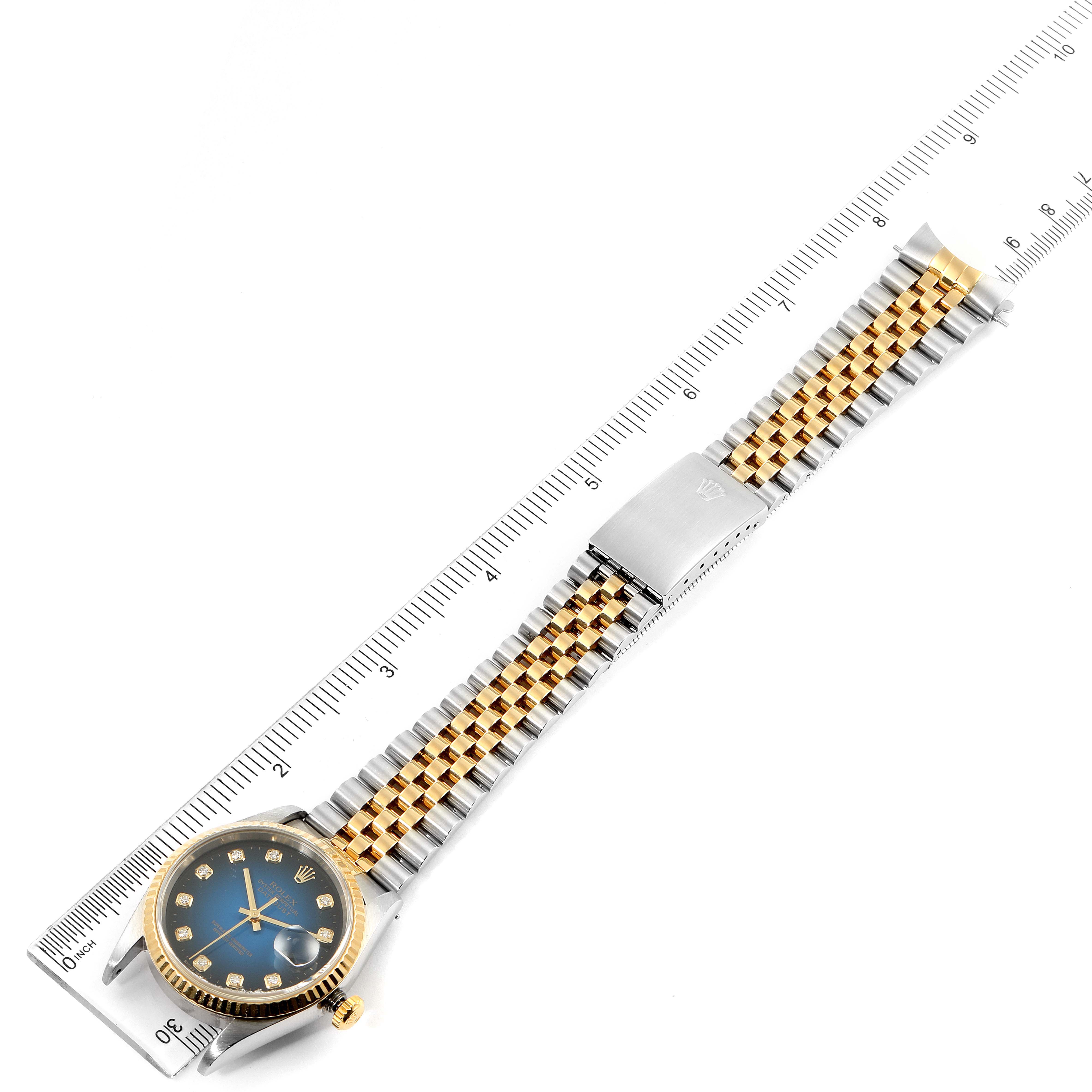 This image shows a top-down view of a Rolex Datejust 16233 Men's Stainless Steel Blue Dial 16233 Men's Stainless Steel Blue Dial watch, highlighting the face, bracelet, and clasp alongside measuring rulers.