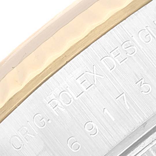 This image shows a close-up view of the engraved side of a Rolex Datejust 69173 Women's Steel and Gold (two tone) Black Dial 69173 Women's Steel and Gold (two tone) Black Dial watch, highlighting the text and part of the bezel.