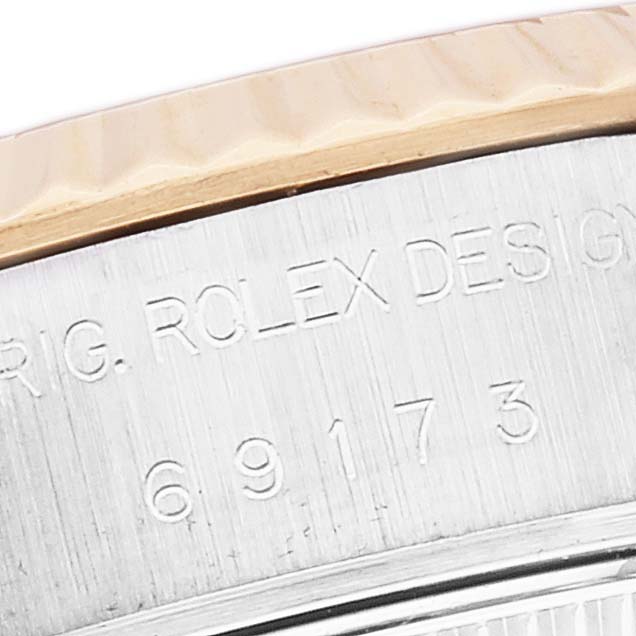 The image shows a close-up angle of the Rolex Datejust 69173 Women's Steel and Gold (two tone) Mother of Pearl Dial 69173 Women's Steel and Gold (two tone) Mother of Pearl Dial watch's engraved side, displaying the bezel and part of the casing.