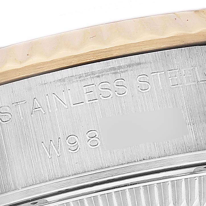 The image shows a close-up angle of the bezel and engraved stainless steel back of a Rolex Datejust 69173 Women's Steel and Gold (two tone) Mother of Pearl Dial 69173 Women's Steel and Gold (two tone) Mother of Pearl Dial watch.