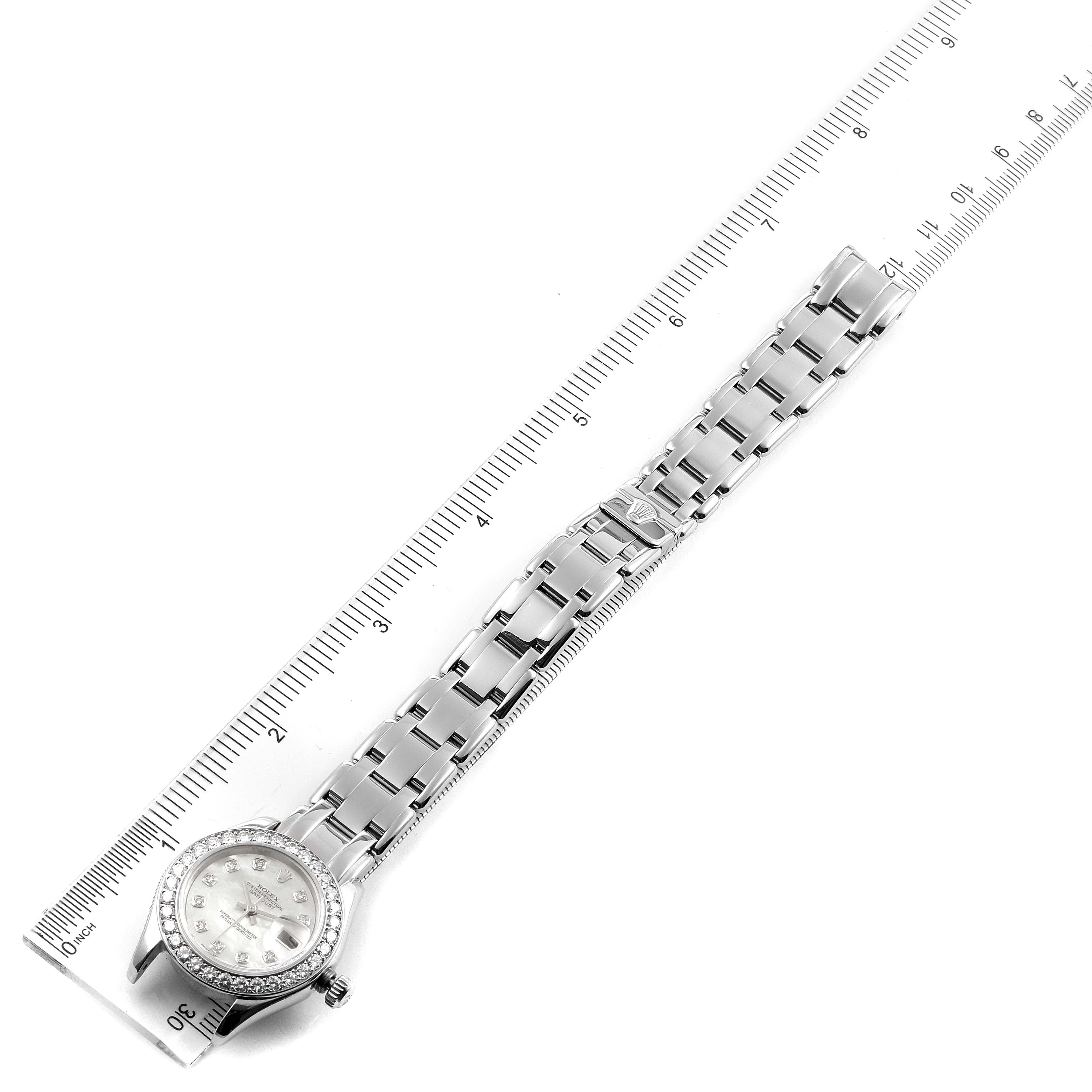 The Rolex Pearlmaster 80299 Women's White Gold Mother of Pearl Dial 80299 Women's White Gold Mother of Pearl Dial watch is shown flat with its bracelet fully extended, alongside a ruler for scale.