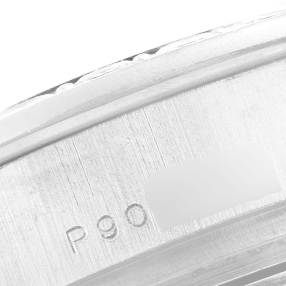 The image shows a close-up of the side of a Rolex Pearlmaster 80299 Women's White Gold Mother of Pearl Dial 80299 Women's White Gold Mother of Pearl Dial watch, revealing part of the case and engravings.