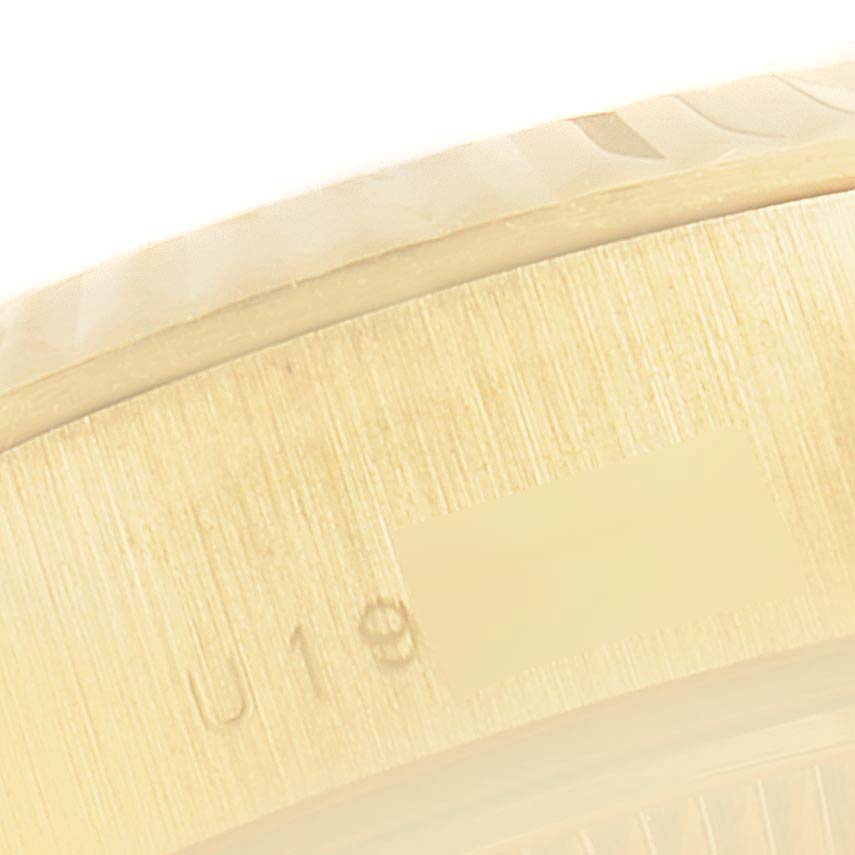 Close-up of the Rolex President 79178 Women
s Yellow Gold Mother of Pearl Dial 79178 Women
s Yellow Gold Mother of Pearl Dial watch showing the side edge of the bezel and part of the case with engraved numbers.