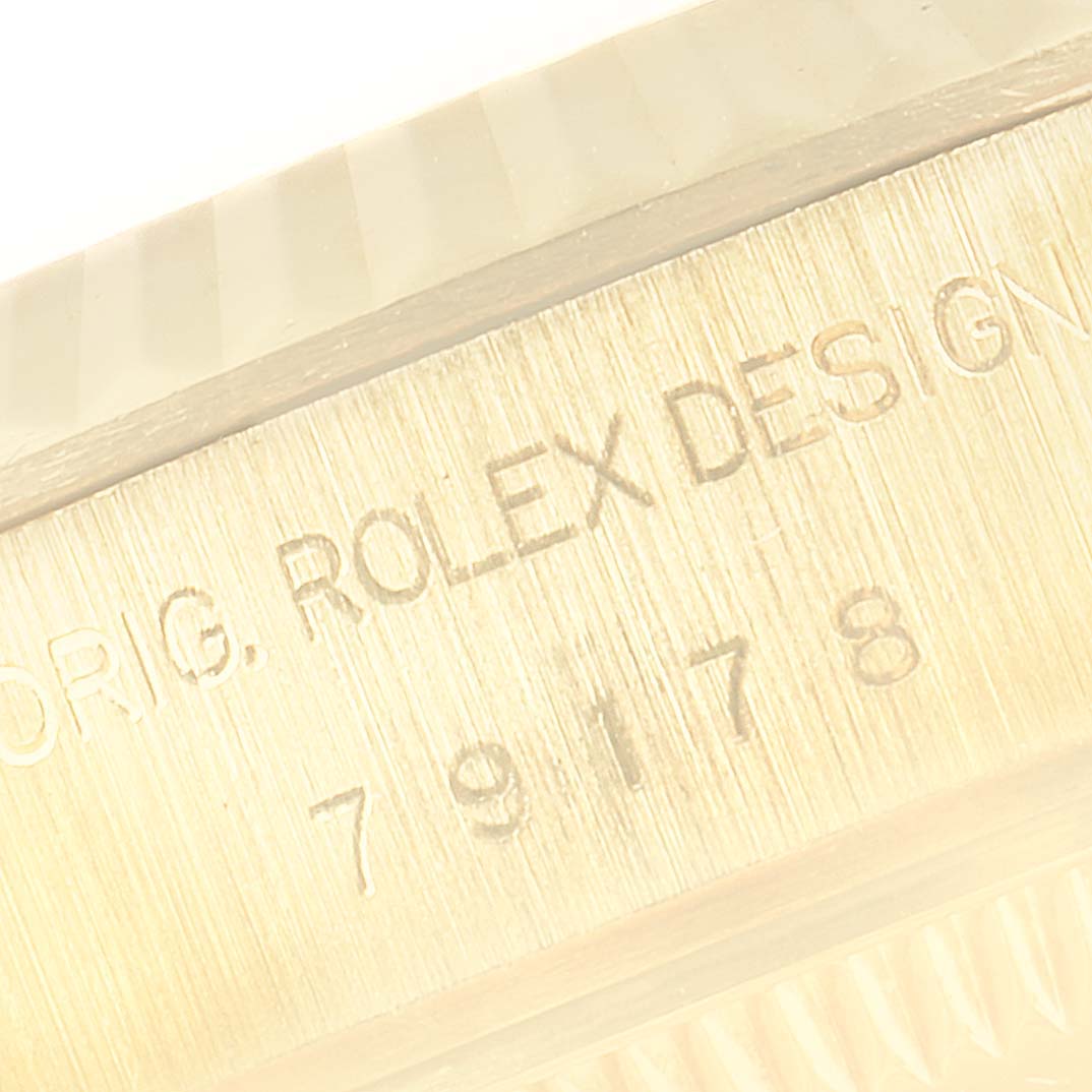 This close-up image shows the engravings on the side of the bezel of a Rolex President 79178 Women
s Yellow Gold Mother of Pearl Dial 79178 Women
s Yellow Gold Mother of Pearl Dial model watch.