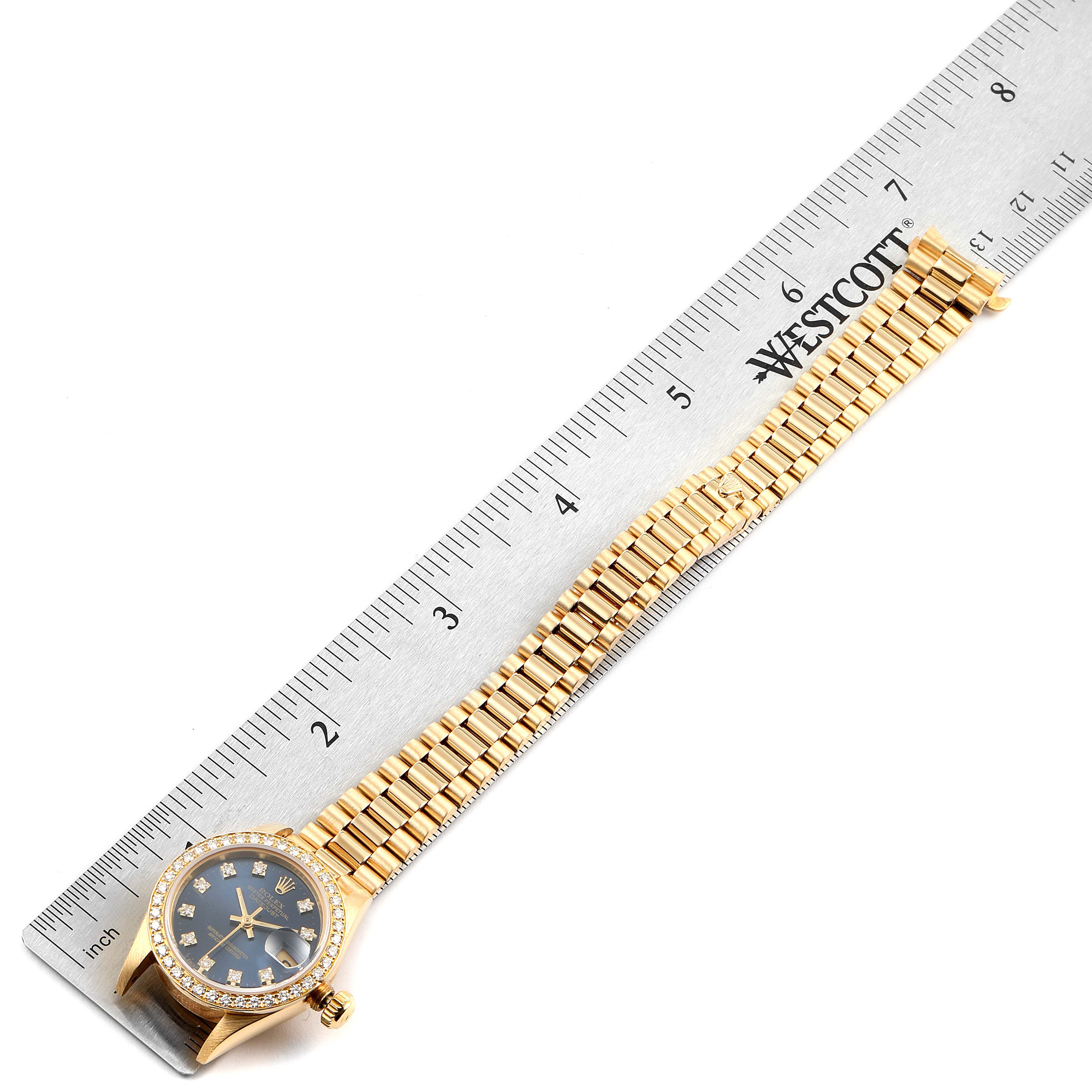 The image shows a Rolex President 69178 Women's Yellow Gold Blue Dial 69178 Women's Yellow Gold Blue Dial model watch, including its dial, bezel, crown, and bracelet, measured against a ruler.