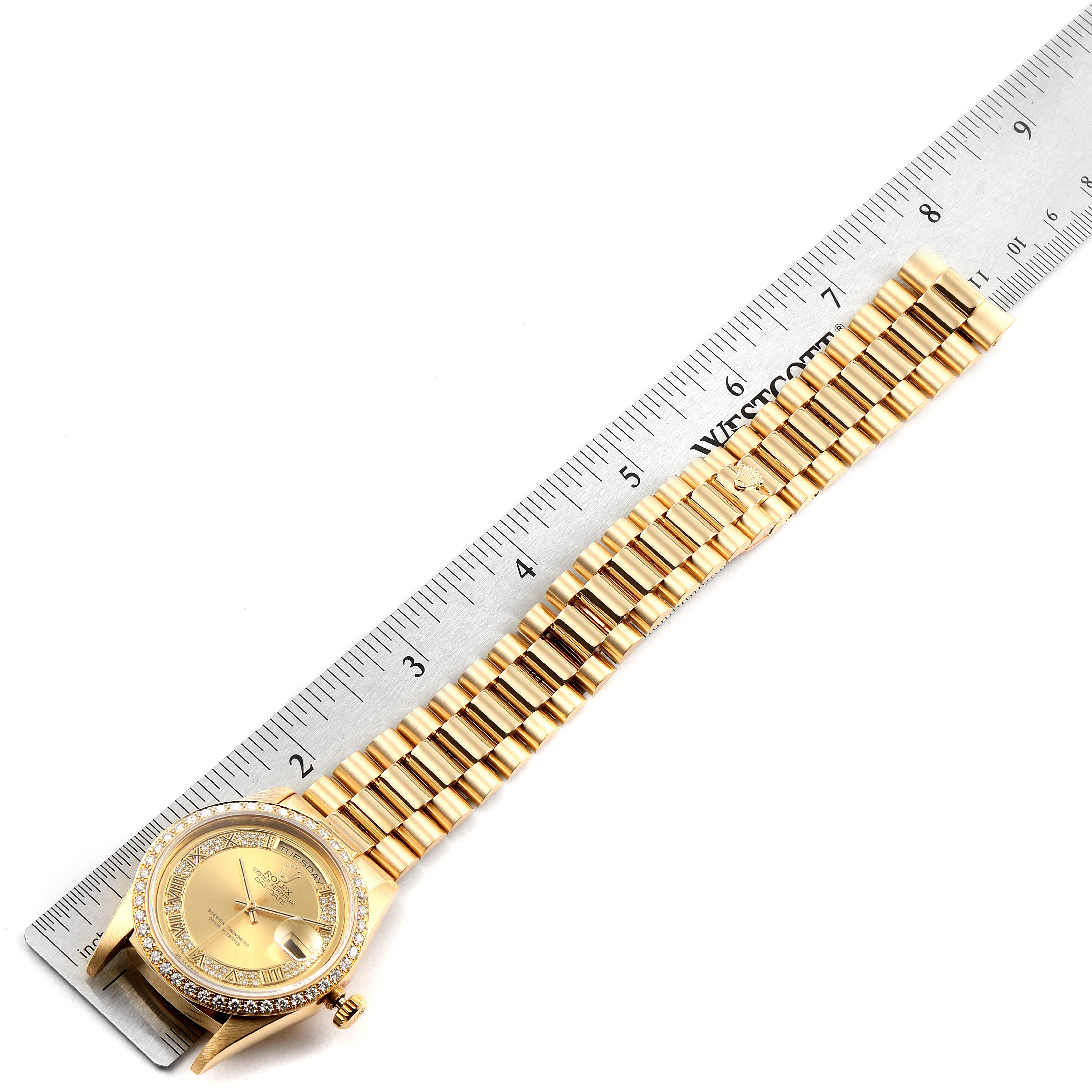 This image shows the Rolex President 18348 Men's Yellow Gold Champagne Dial 18348 Men's Yellow Gold Champagne Dial model watch laid flat next to a ruler, displaying its face, bezel, and full bracelet.