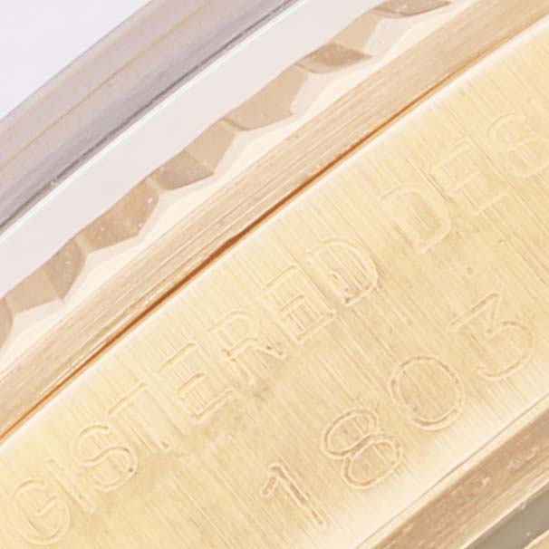 This close-up angle shows a portion of the bezel and case with "REGISTERED DESIGN 1803" engraved on the Vintage Collection Rolex watch.