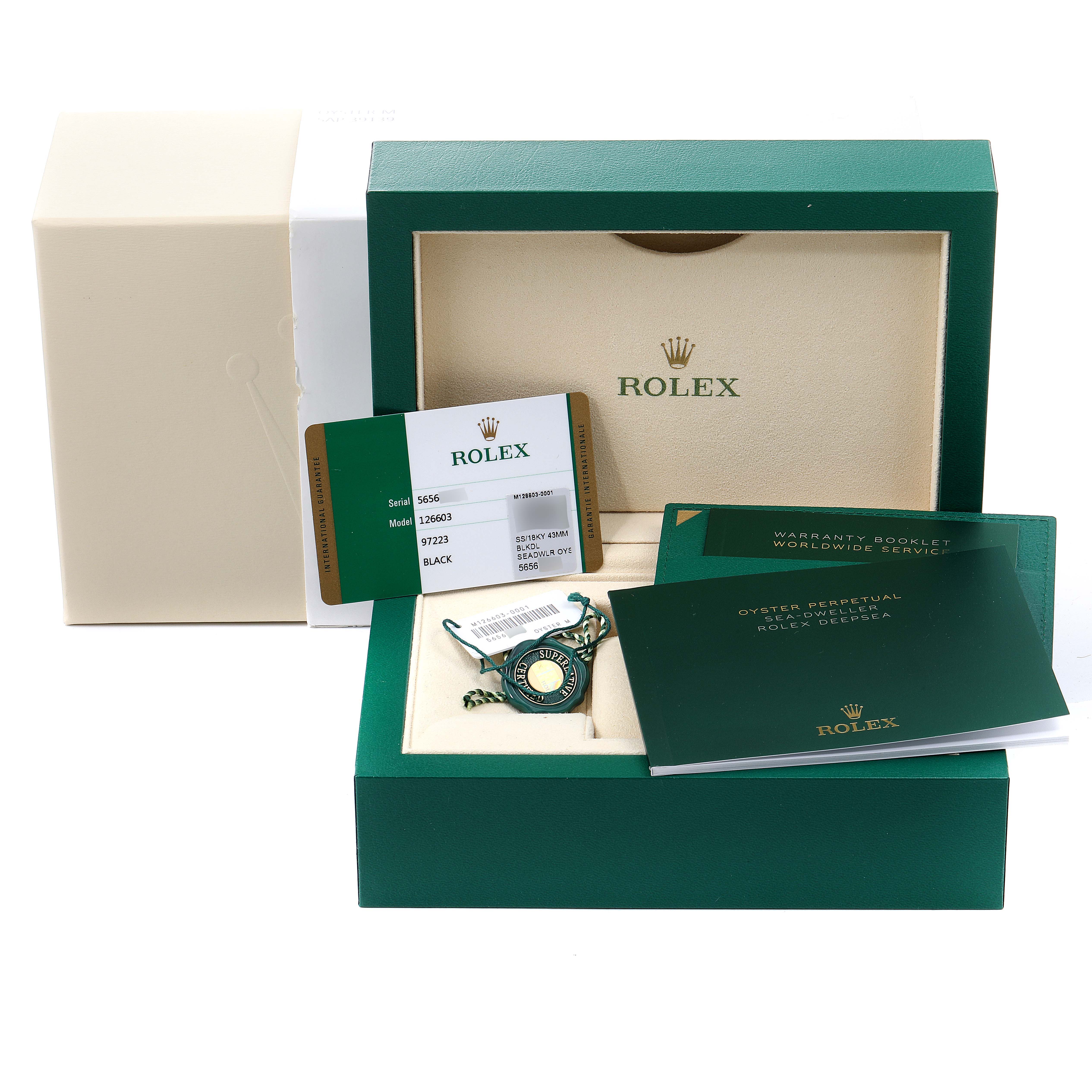 The image shows a Rolex Sea-Dweller 126603 Men
s Steel and Gold (two tone) Black Dial 126603 Men
s Steel and Gold (two tone) Black Dial watch box, warranty card, booklets, and tags.