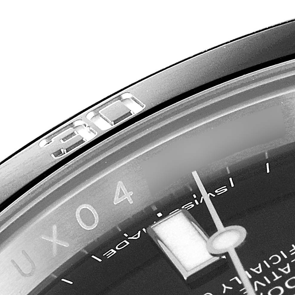 This close-up of the Rolex Submariner 116610 Men
s Stainless Steel Black Dial 116610 Men
s Stainless Steel Black Dial watch shows a portion of the bezel with the "90" mark, part of the dial, and the hands.