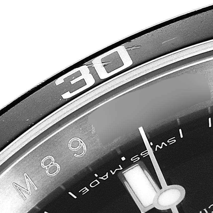 This image shows a close-up of the bezel and part of the dial of a Rolex Submariner 16610 Men's Stainless Steel Black Dial 16610 Men's Stainless Steel Black Dial watch, highlighting the 30-minute mark.