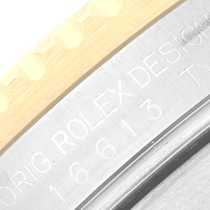 This close-up image shows the engraved side of the bezel and case of a Rolex Submariner 16613 Men
s Stainless Steel Blue Dial 16613 Men
s Stainless Steel Blue Dial, featuring part of the model number and branding.