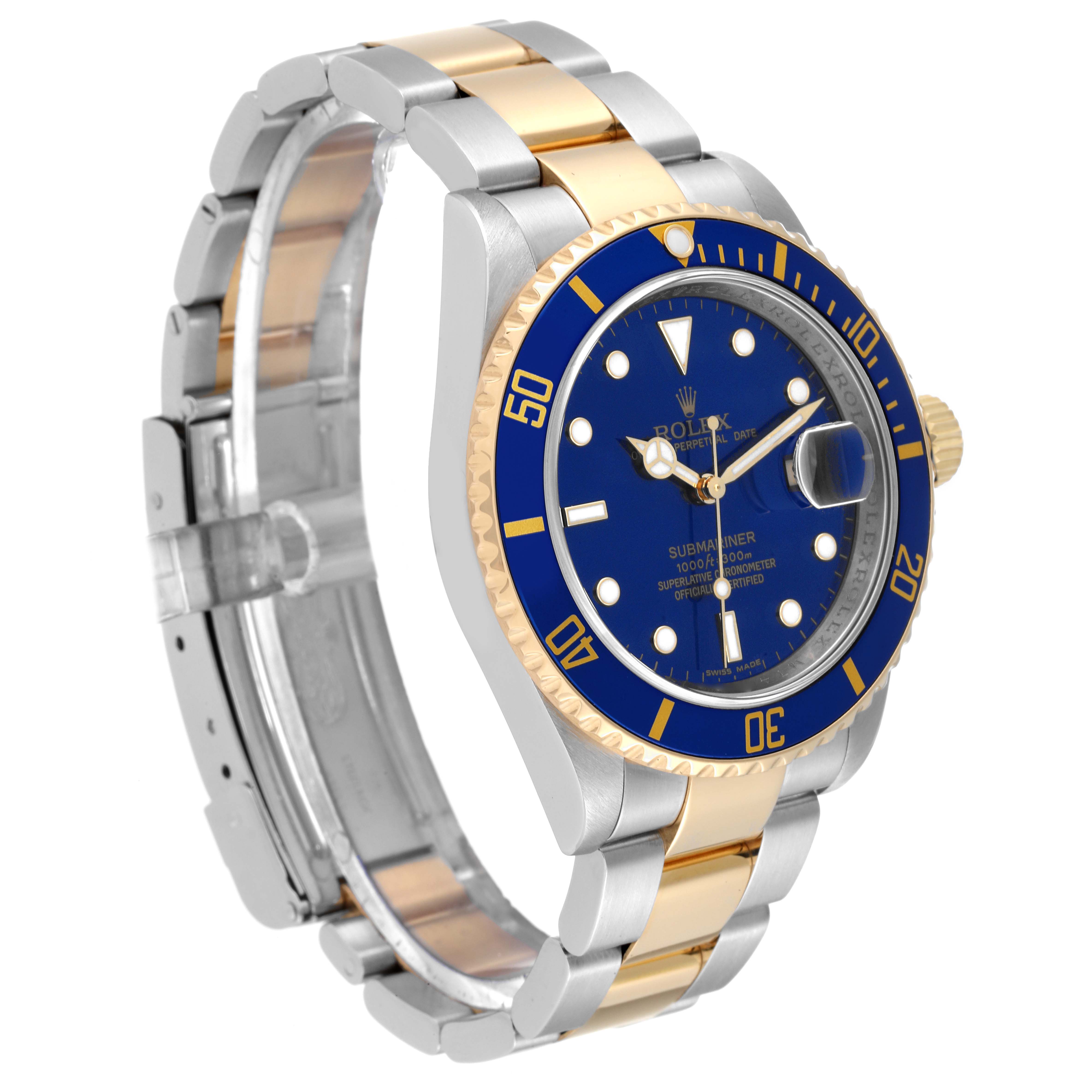 The Rolex Submariner 16613 Men
s Stainless Steel Blue Dial 16613 Men
s Stainless Steel Blue Dial watch is displayed at a three-quarter angle, showing its blue dial, blue bezel, and two-tone metal bracelet.