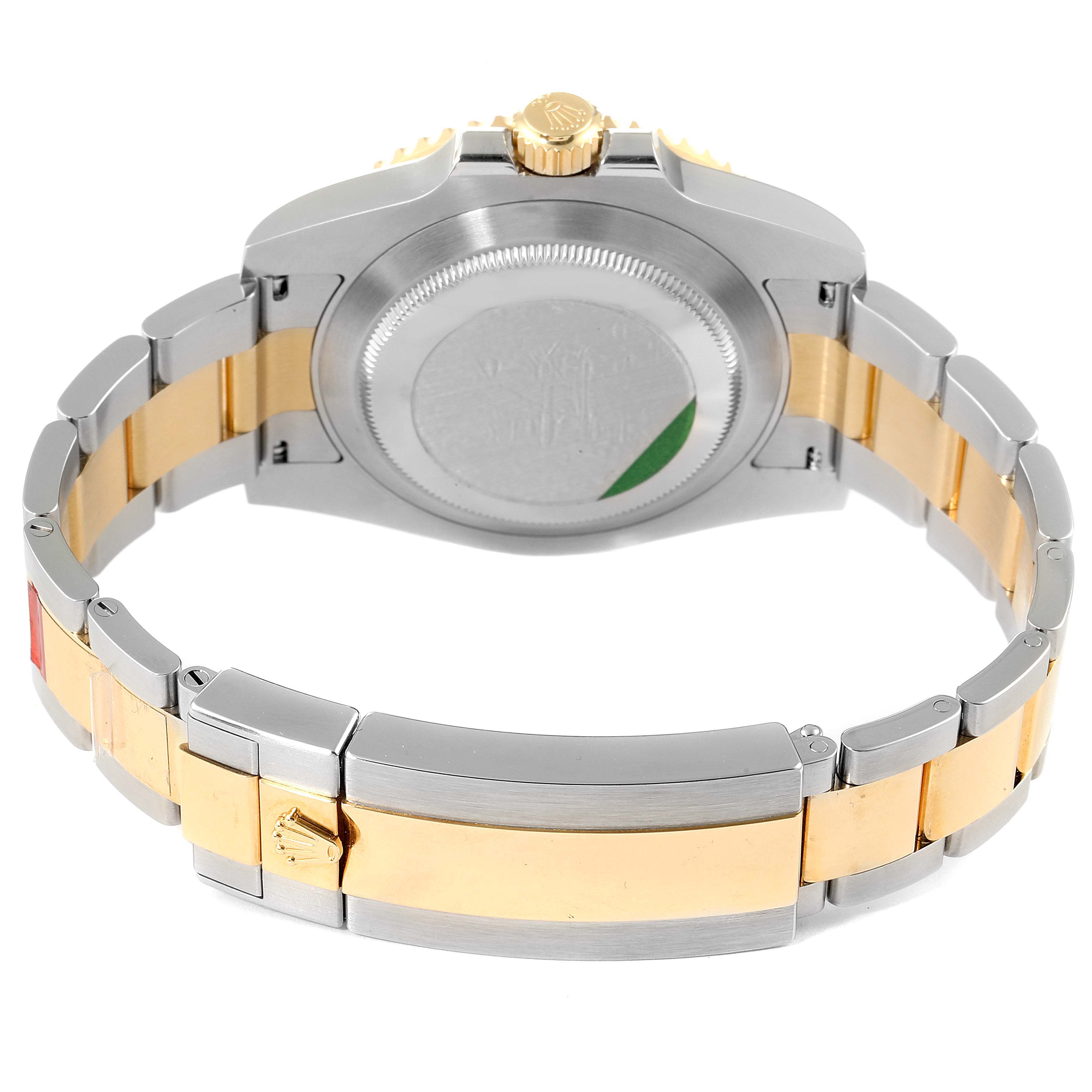 The image shows the back of a Rolex Submariner 116613 Men's Steel and Gold (two tone) Blue Dial 116613 Men's Steel and Gold (two tone) Blue Dial watch, highlighting its two-tone stainless steel and gold bracelet and clasp.