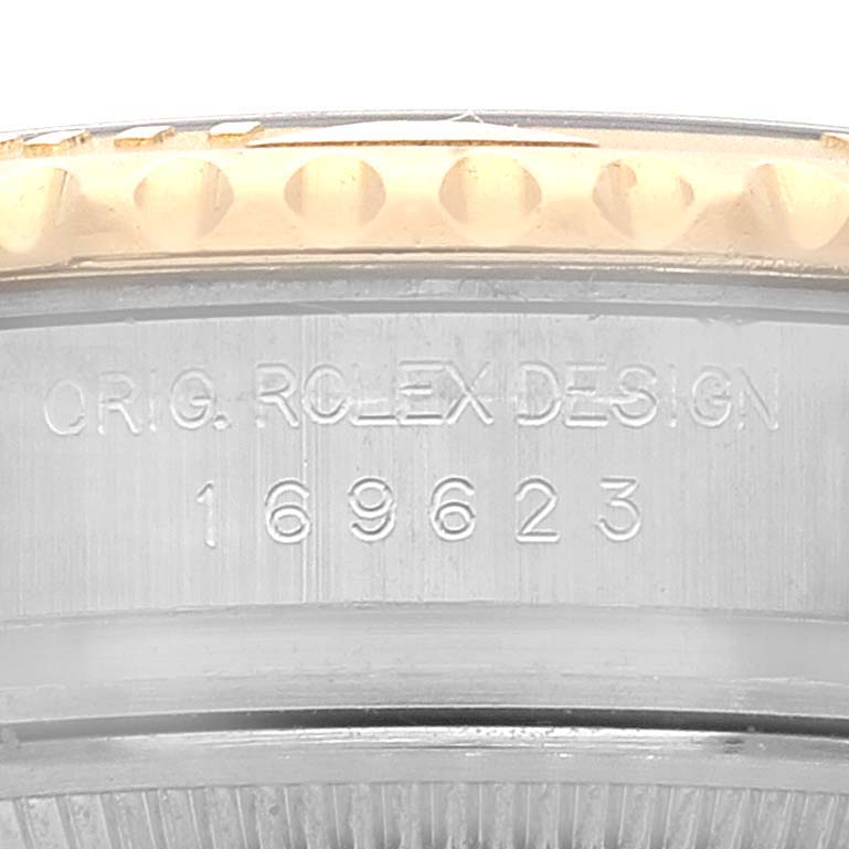 This image shows a close-up of the case side of a Rolex Yacht-Master 169623 Women's Steel and Gold (two tone) Blue Dial 169623 Women's Steel and Gold (two tone) Blue Dial, including the model number and "ORIG. ROLEX DESIGN" engraving.