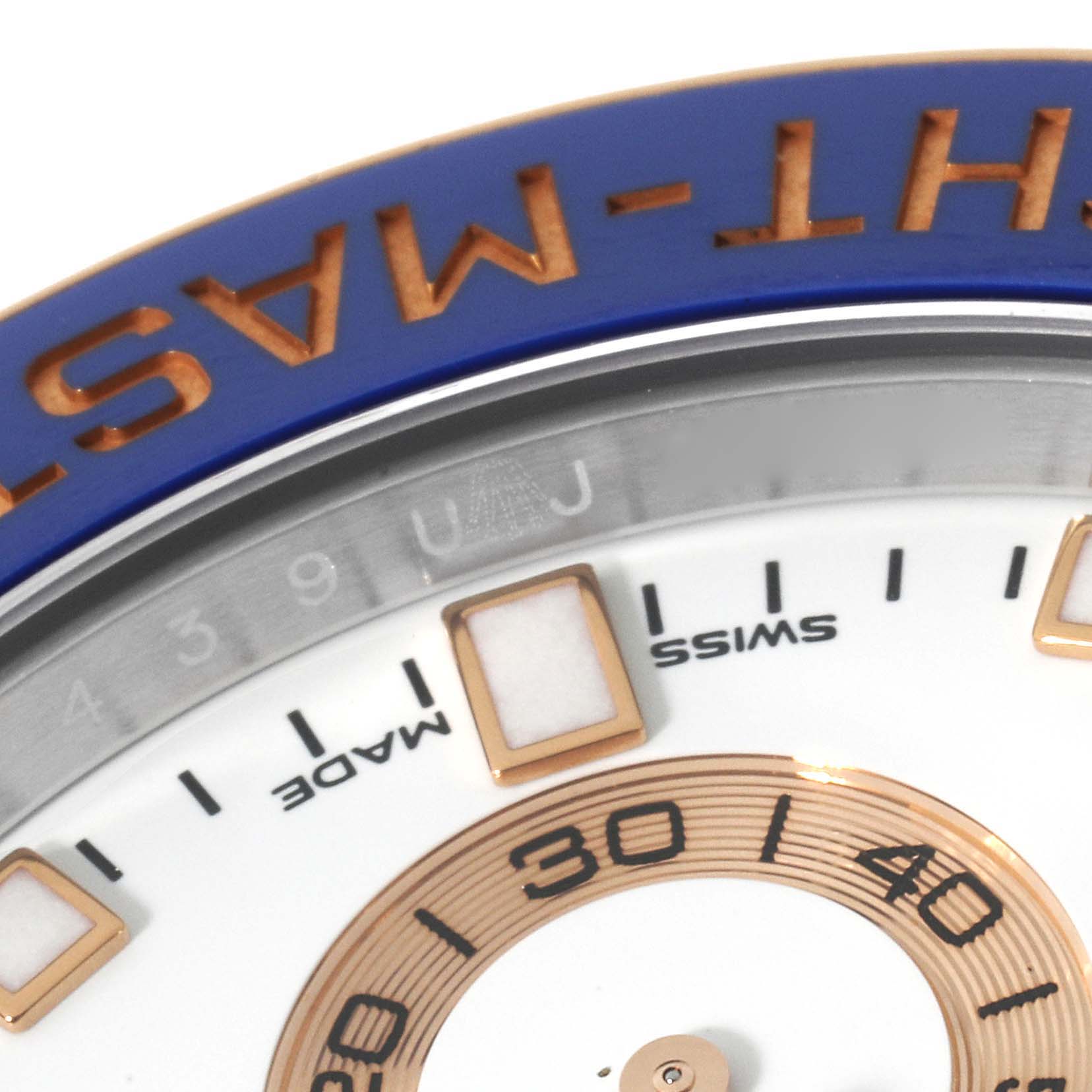 The image shows a close-up of the dial and bezel of a Rolex Yacht-Master 116681 Men's Steel and Gold (two tone) White Dial 116681 Men's Steel and Gold (two tone) White Dial watch, focusing on the wording and some hour markers.