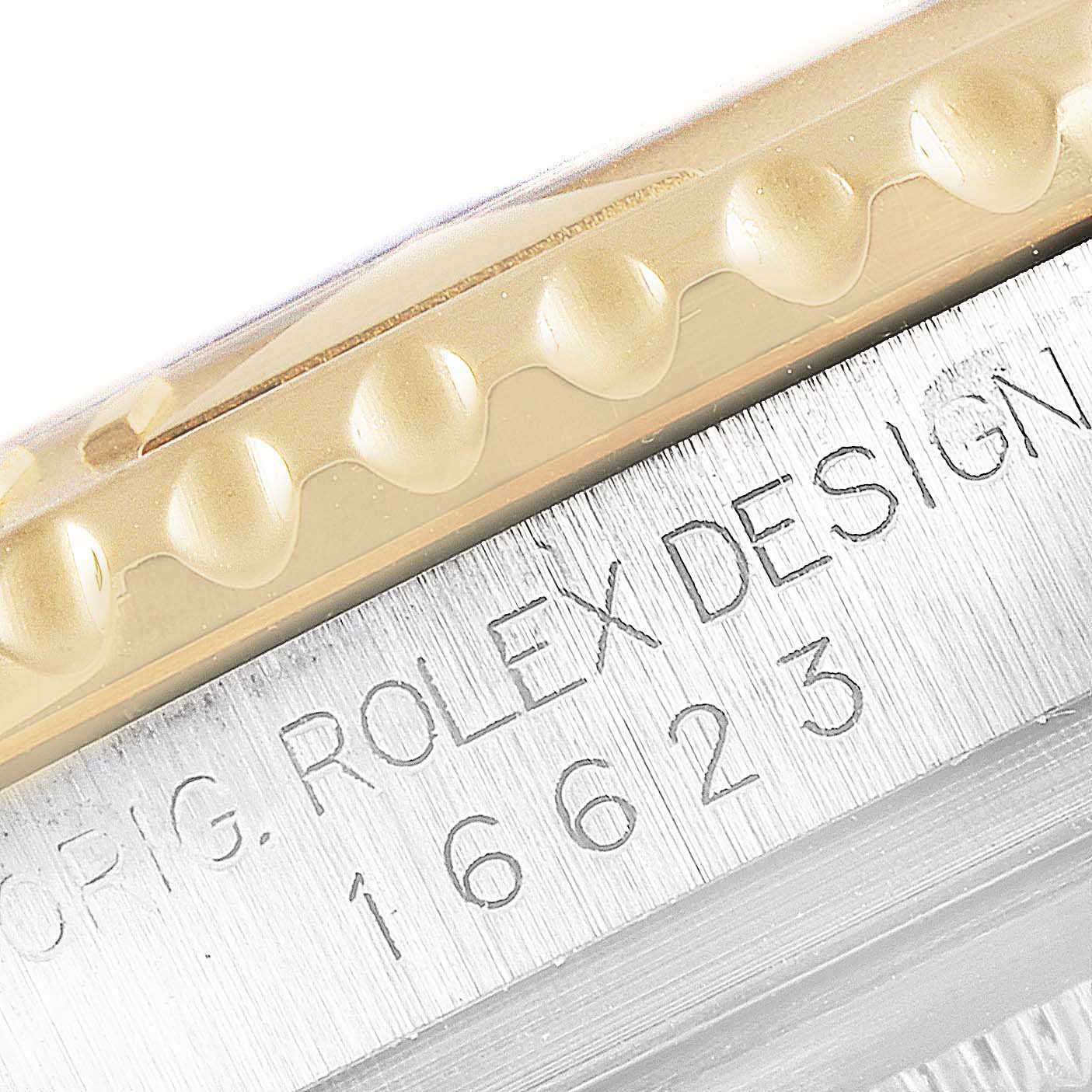 Close-up of the bezel edge and case side showing the "ORIG. ROLEX DESIGN 16623" engraving on the Rolex Yacht-Master 16623 Men's Steel and Gold (two tone) Champagne Dial 16623 Men's Steel and Gold (two tone) Champagne Dial.