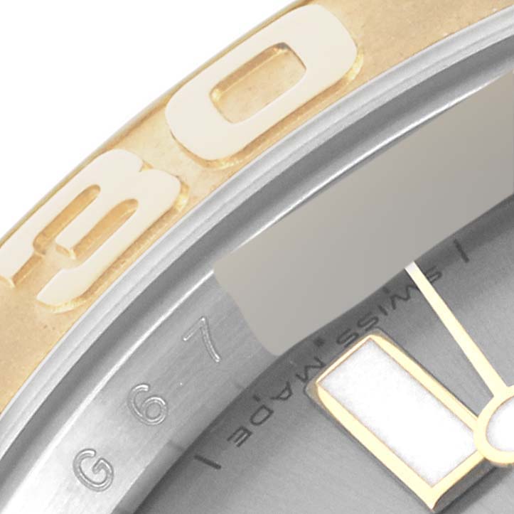 This close-up image of a Rolex Yacht-Master 16623 Men's Steel and Gold (two tone) Grey Dial 16623 Men's Steel and Gold (two tone) Grey Dial watch shows the bezel, part of the dial, and an hour marker.
